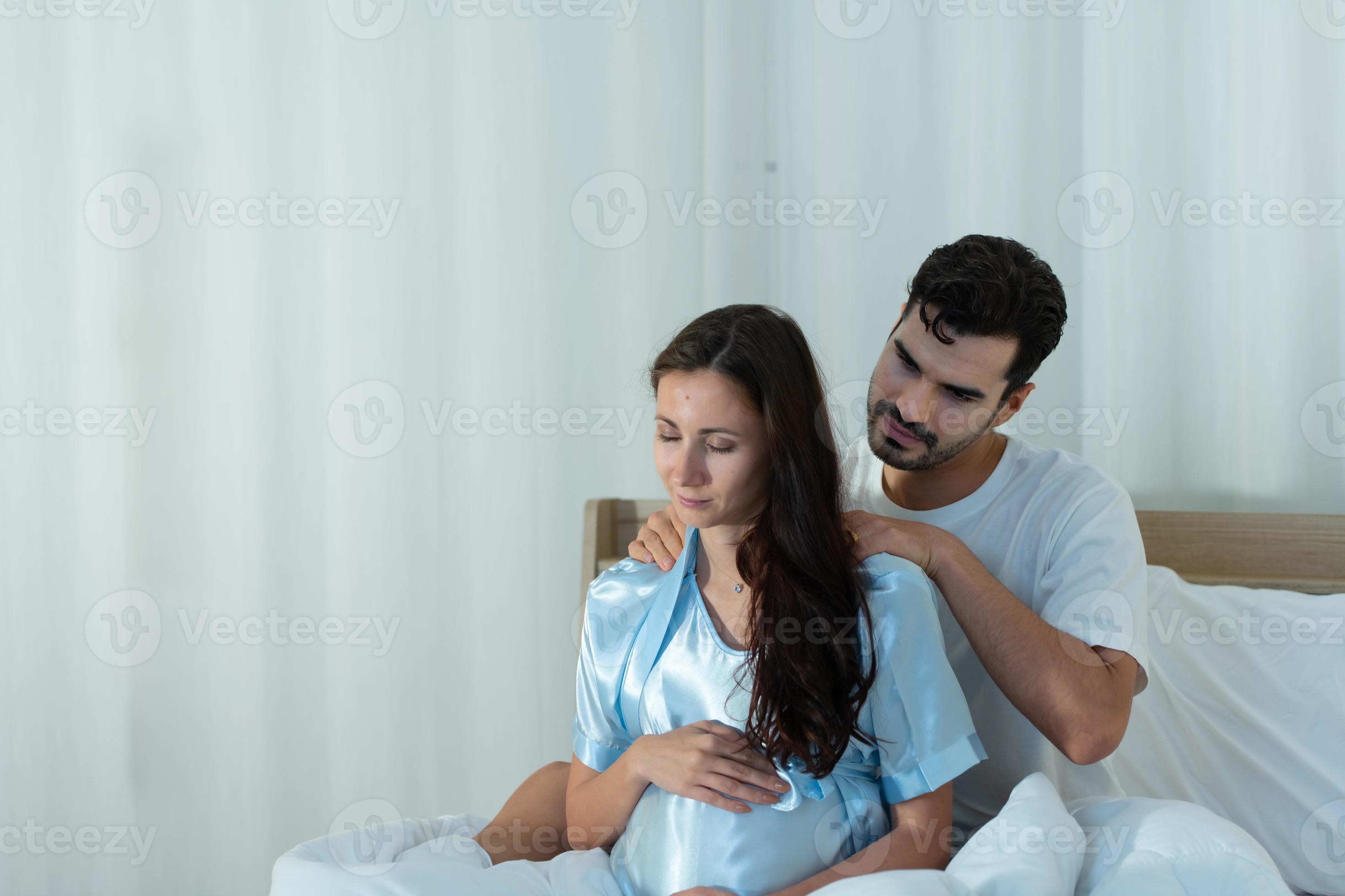 Husband giving a pregnant wife a image
