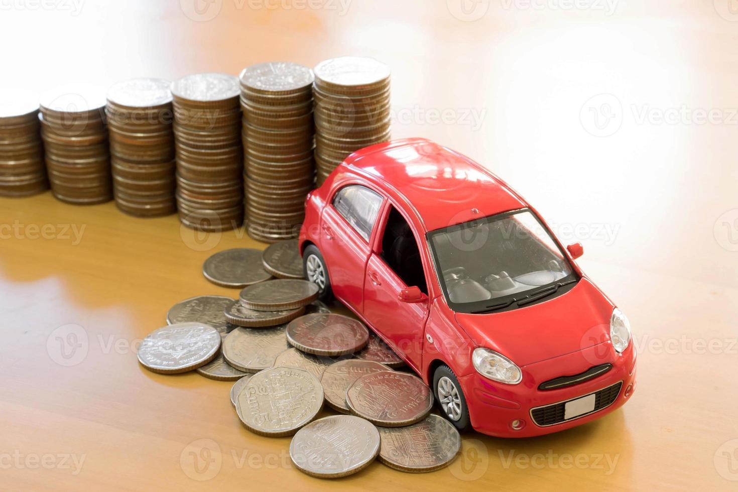 red car over a lot of stacked coins photo