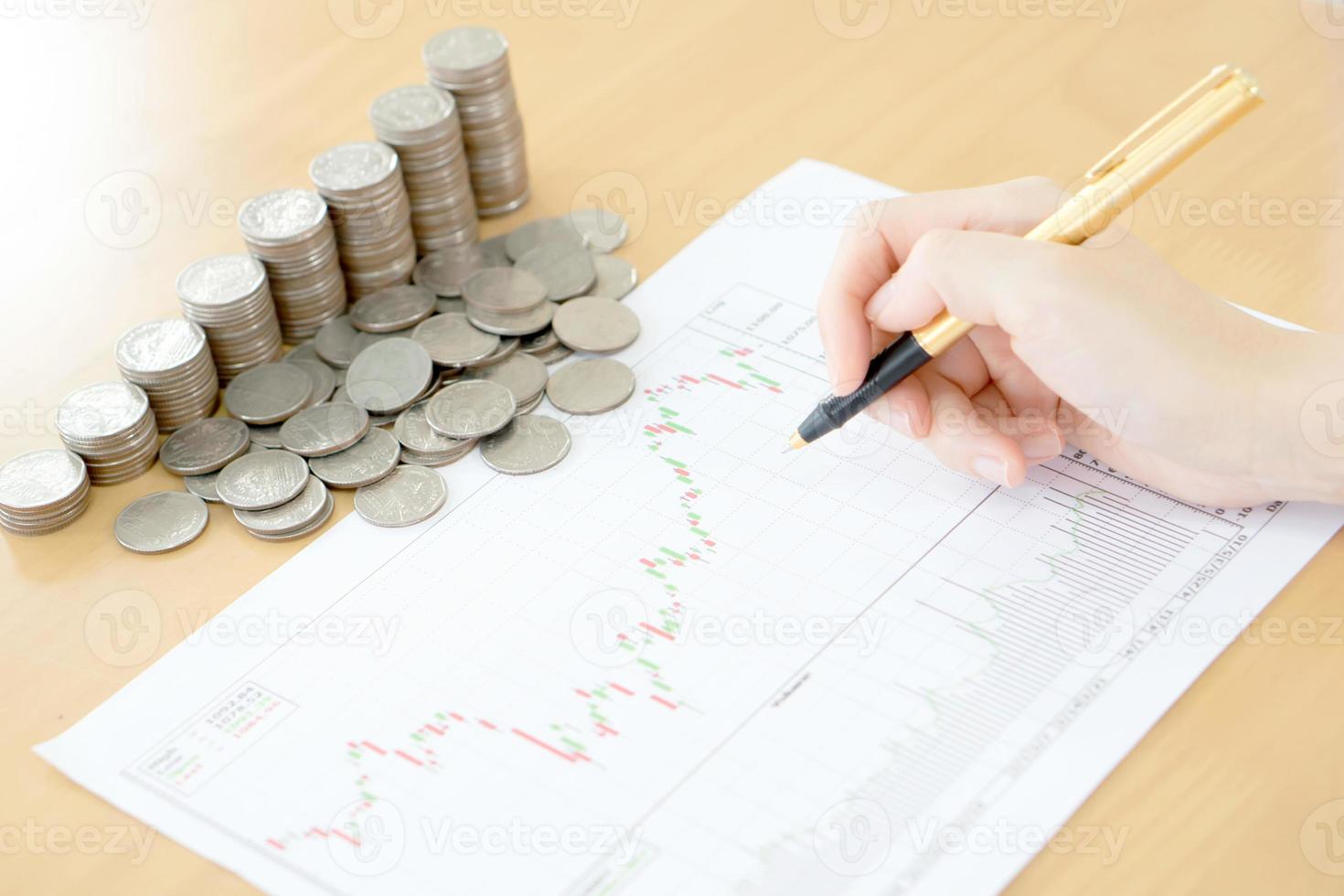 Summary report and financial analyzing concept, Pen and coins photo