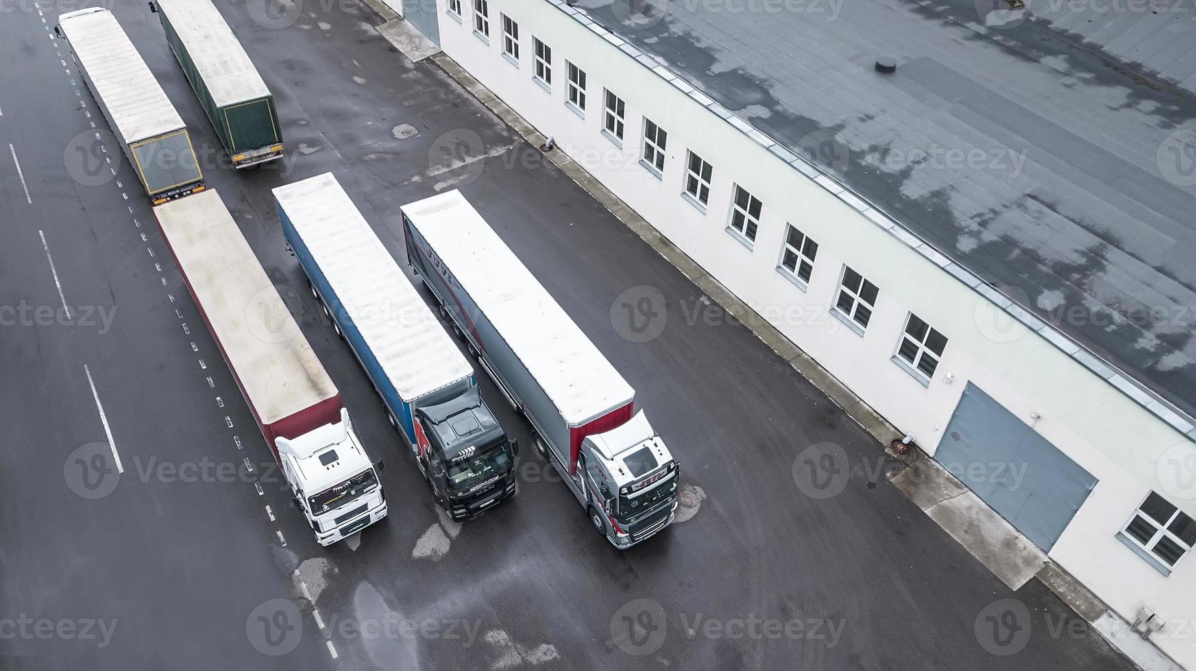 trucks are waiting to be loaded in the logistics center top view aerial photography from a drone photo