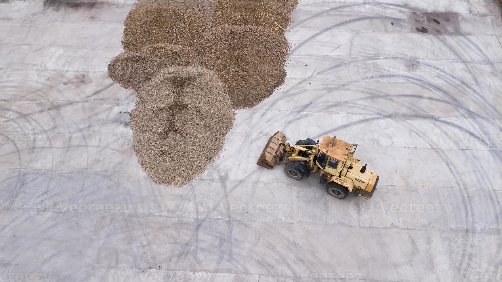 the loader loads the potatoes, top view photo