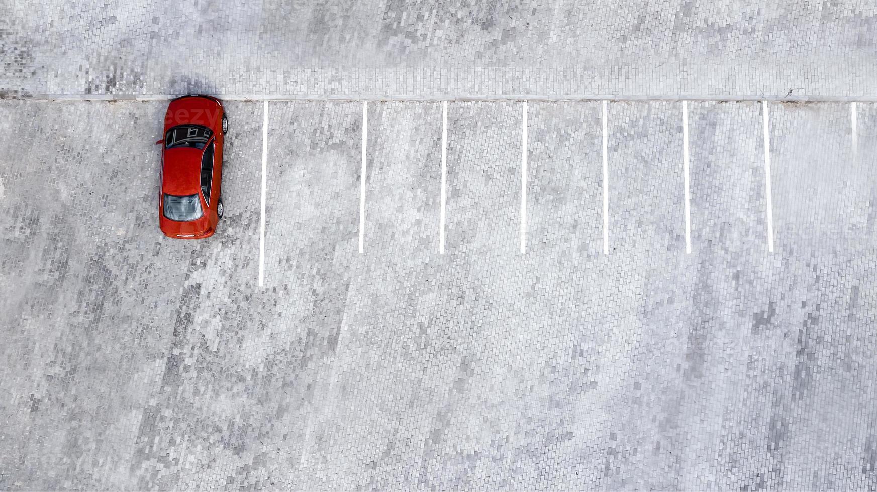 red car stands in the Parking lot top view from the drone photo