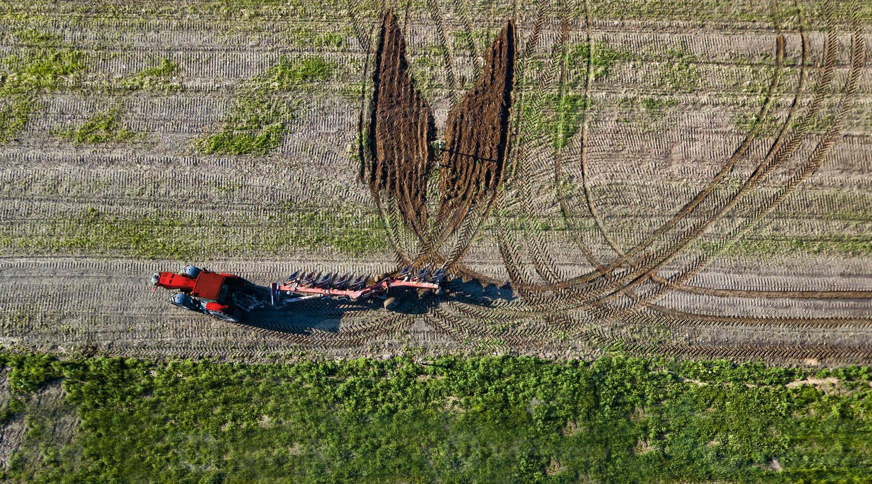 creative tractor driver drew a butterfly on the field aerial view photo
