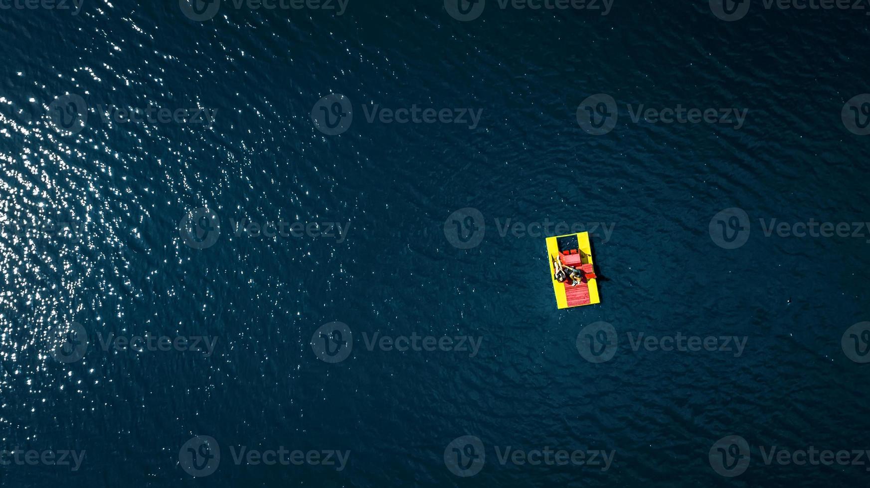 catamaran with people on the water top view photo