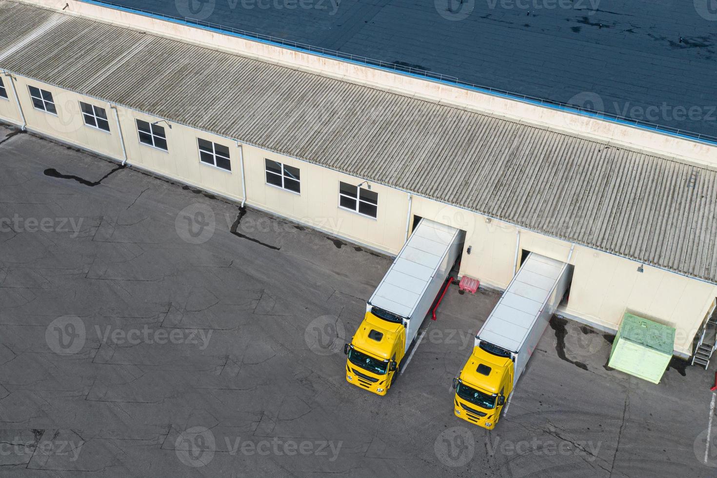 Loading trucks in a logistics center top view from a drone photo