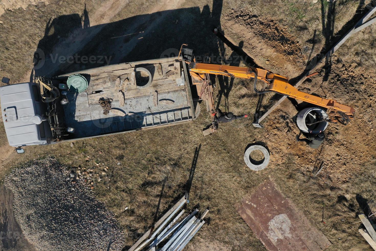 unloading concrete rings for the construction of wells and sewers top view photo