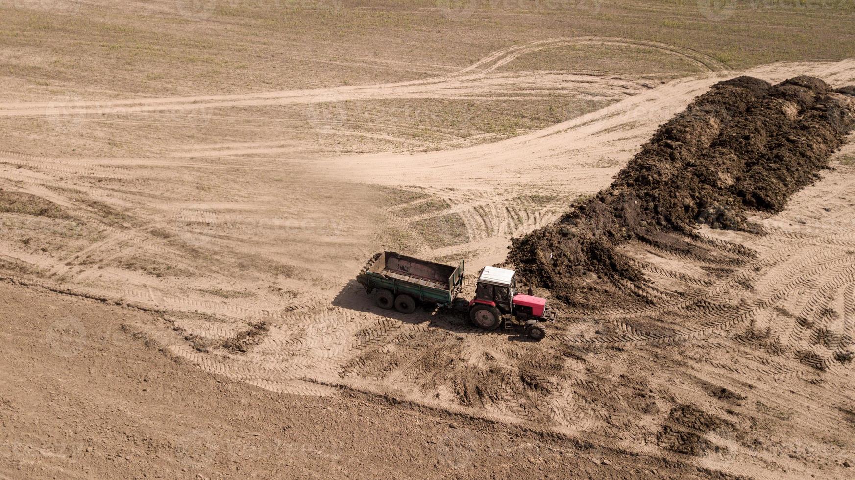 Loading fertilizers excavator. Fertilizer on the field. photo