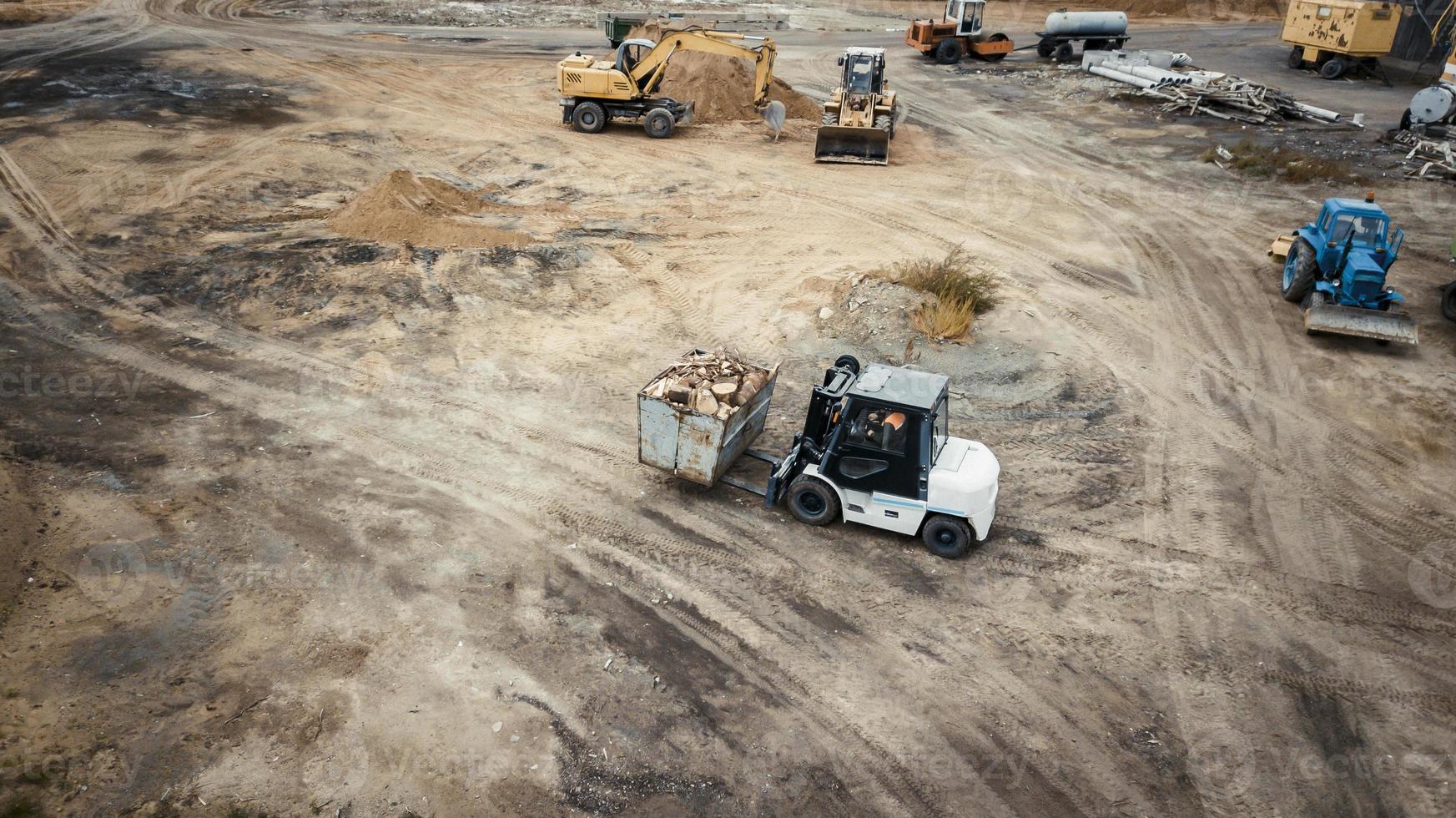 loader carries firewood top view from the drone photo