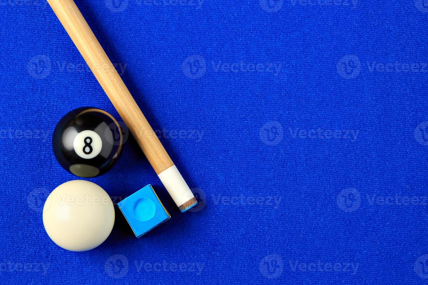 Billiard balls, cue and chalk on a blue pool table. Viewed from above. Horizontal image. photo