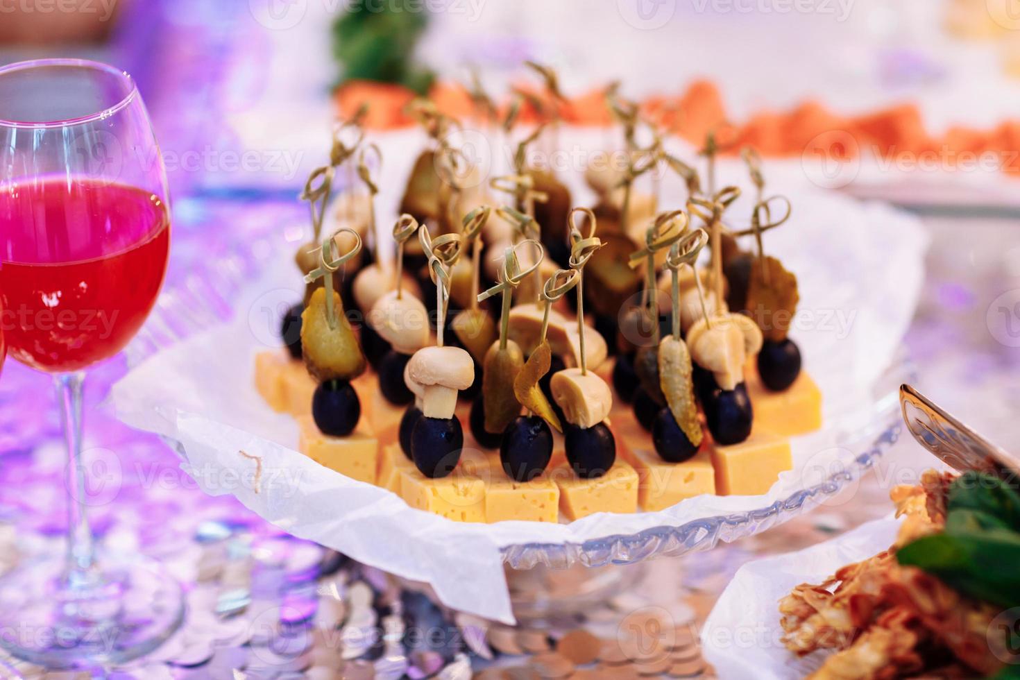 Beautifully decorated banquet table with cold snacks with meat, egetables and cheese . A variety of delicious delicious snacks on the table photo