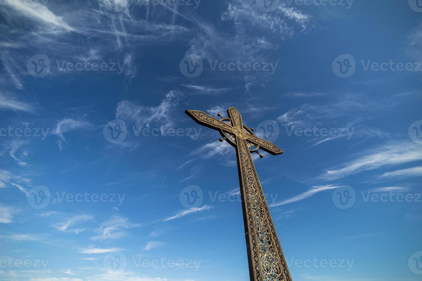 church cross on sky background with clouds photo