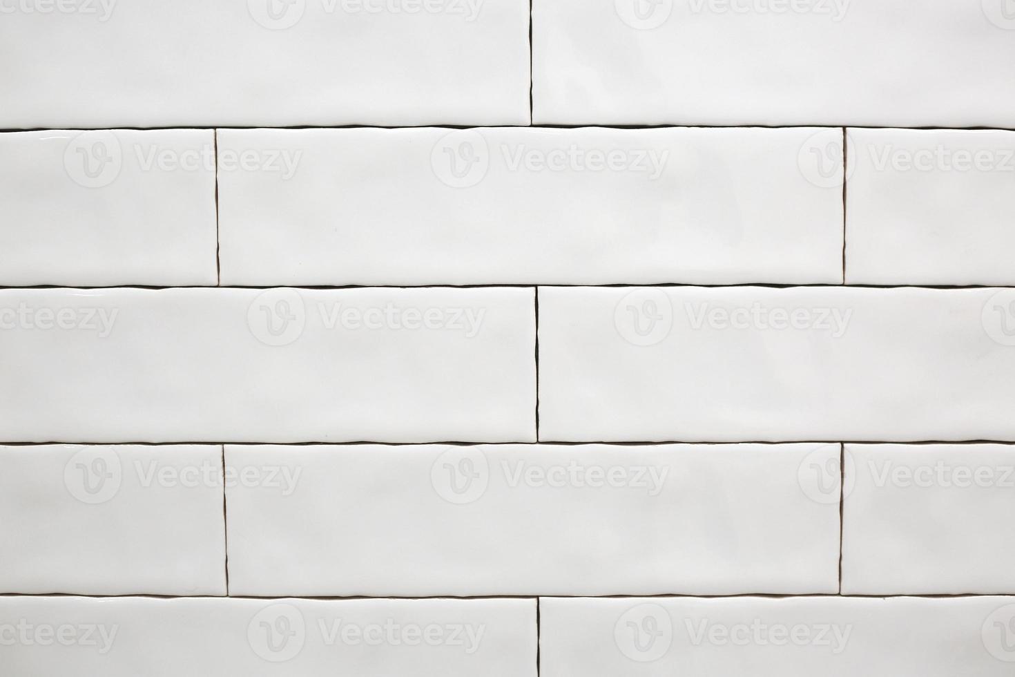 Rectangular white ceramic tile on the kitchen wall. Repairs in the kitchen. Stylish trendy white ceramic tiles. Renovation of apartments and bathrooms. photo
