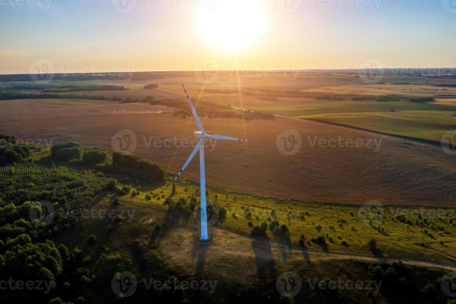 wind generator on the background of the setting sun top view from a drone photo