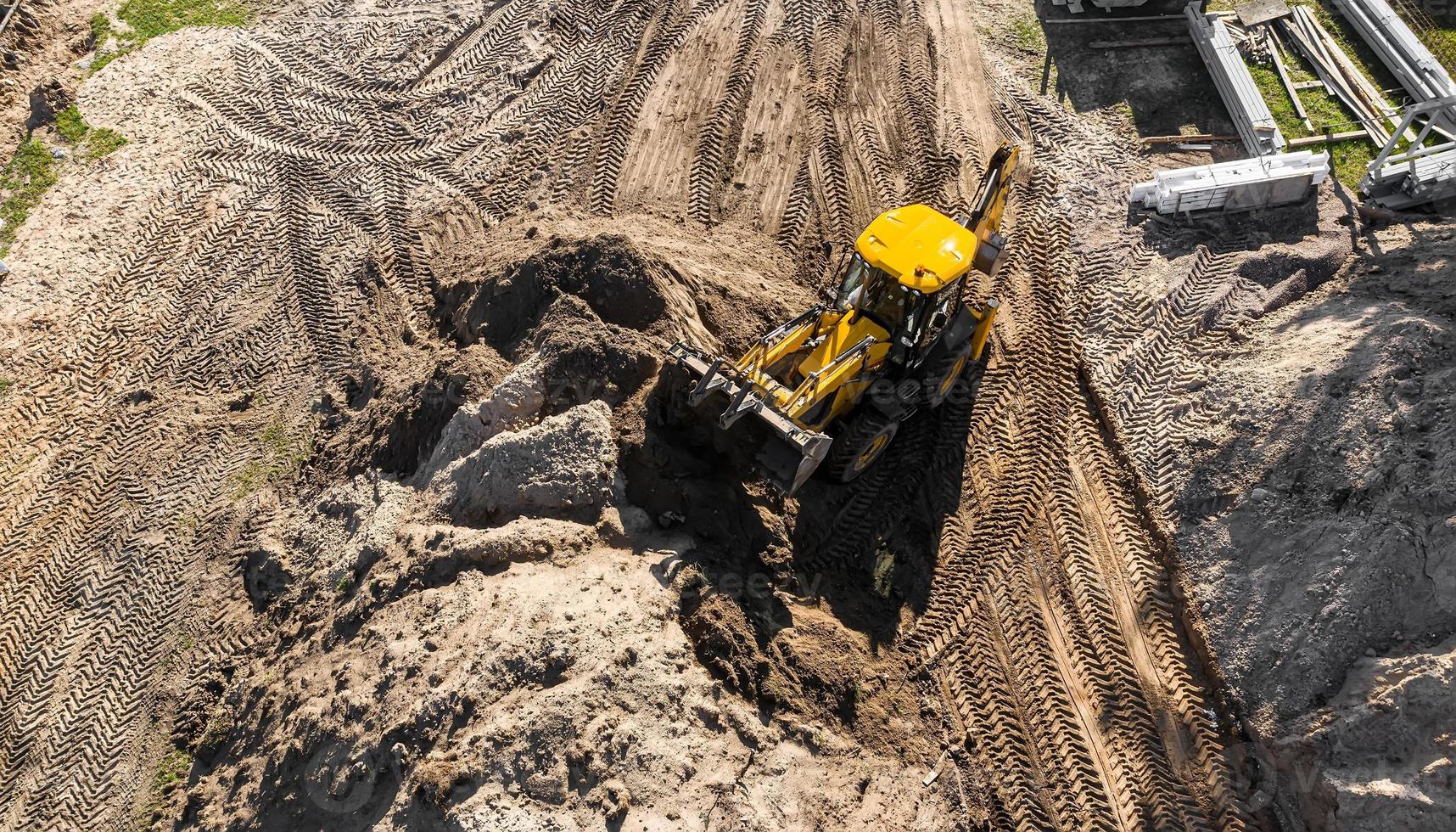 excavator working on a construction site top view photo