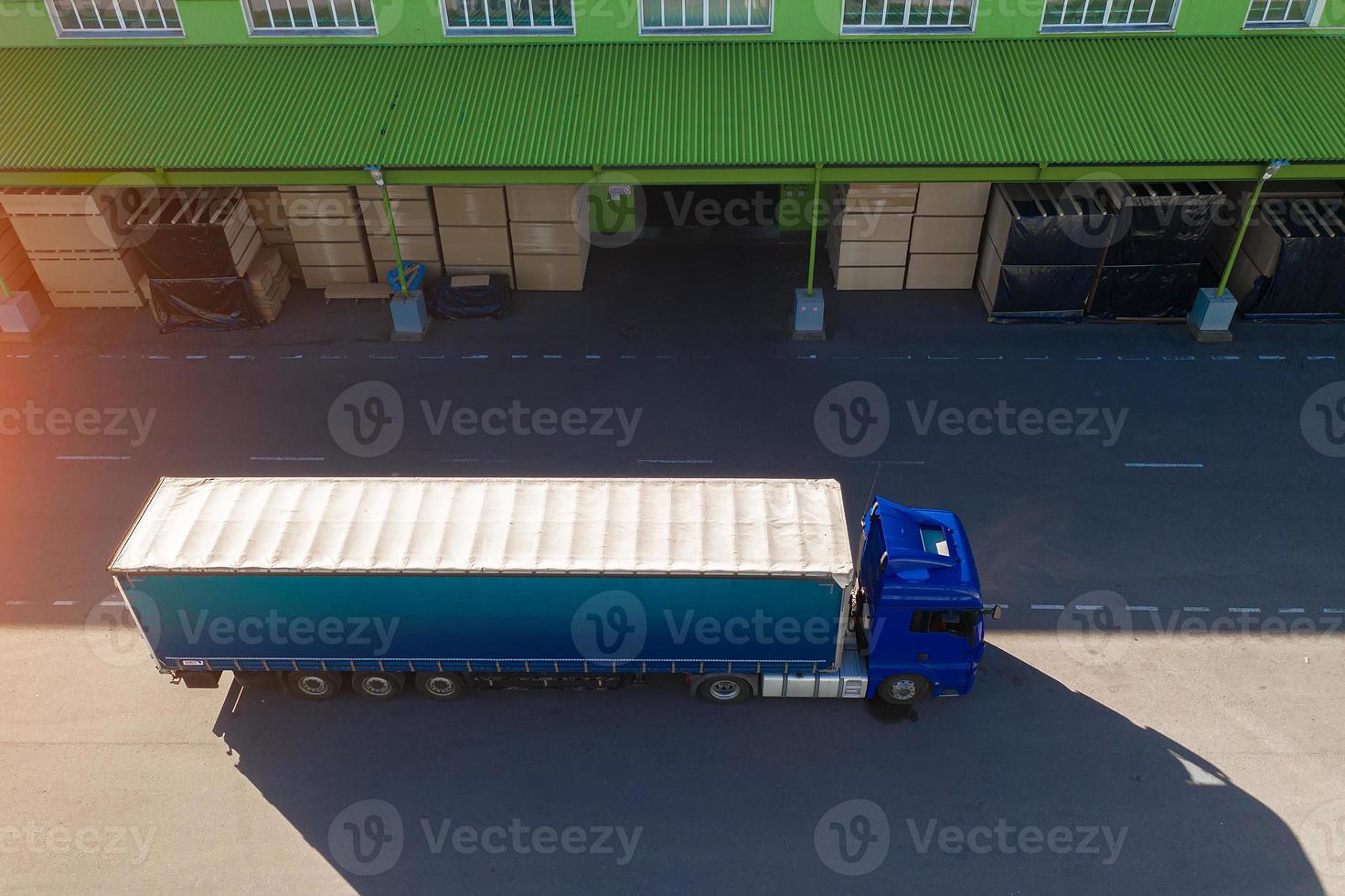 the truck is waiting to load at the factory top view photo