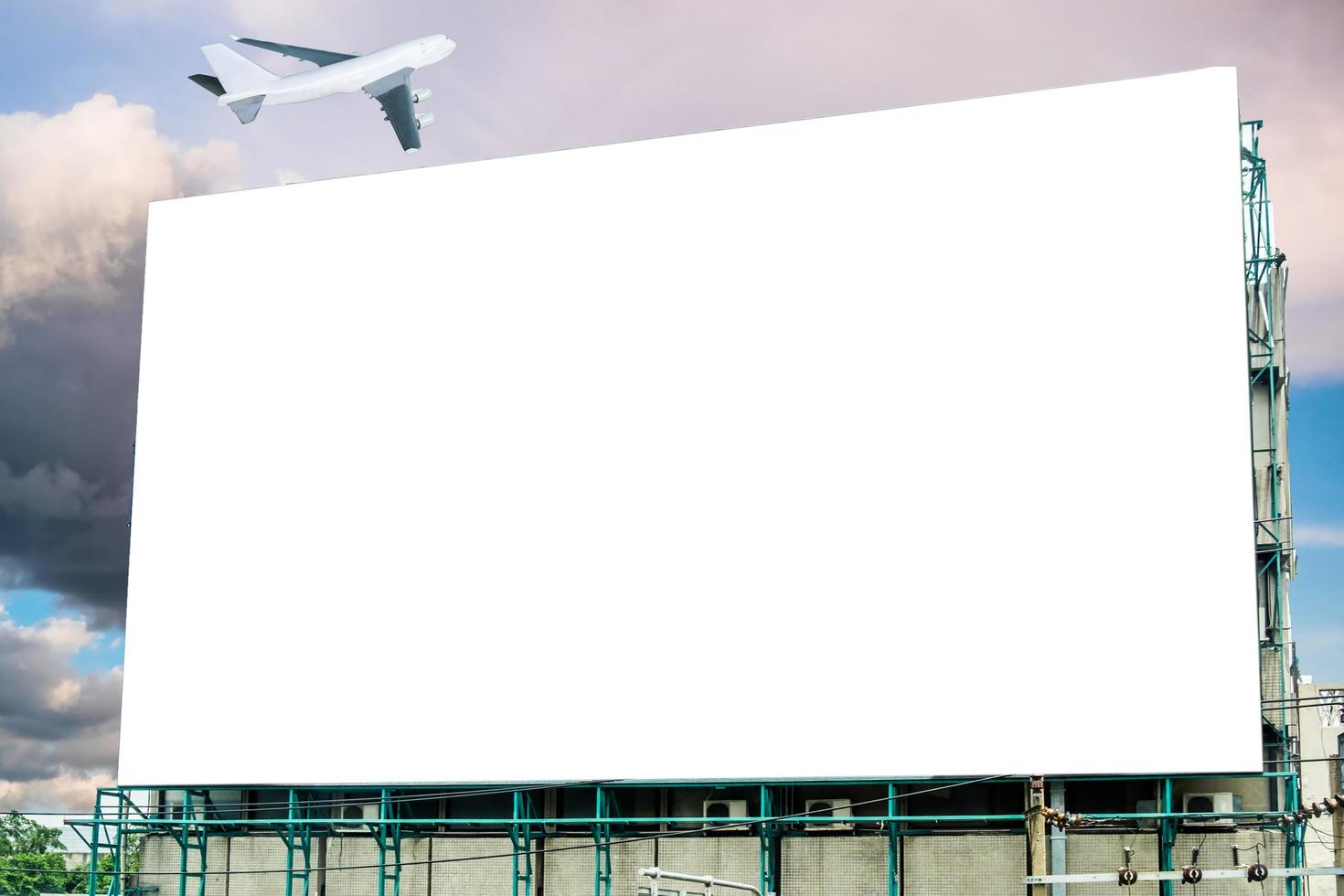Large billboard white blank and airplane on sky photo