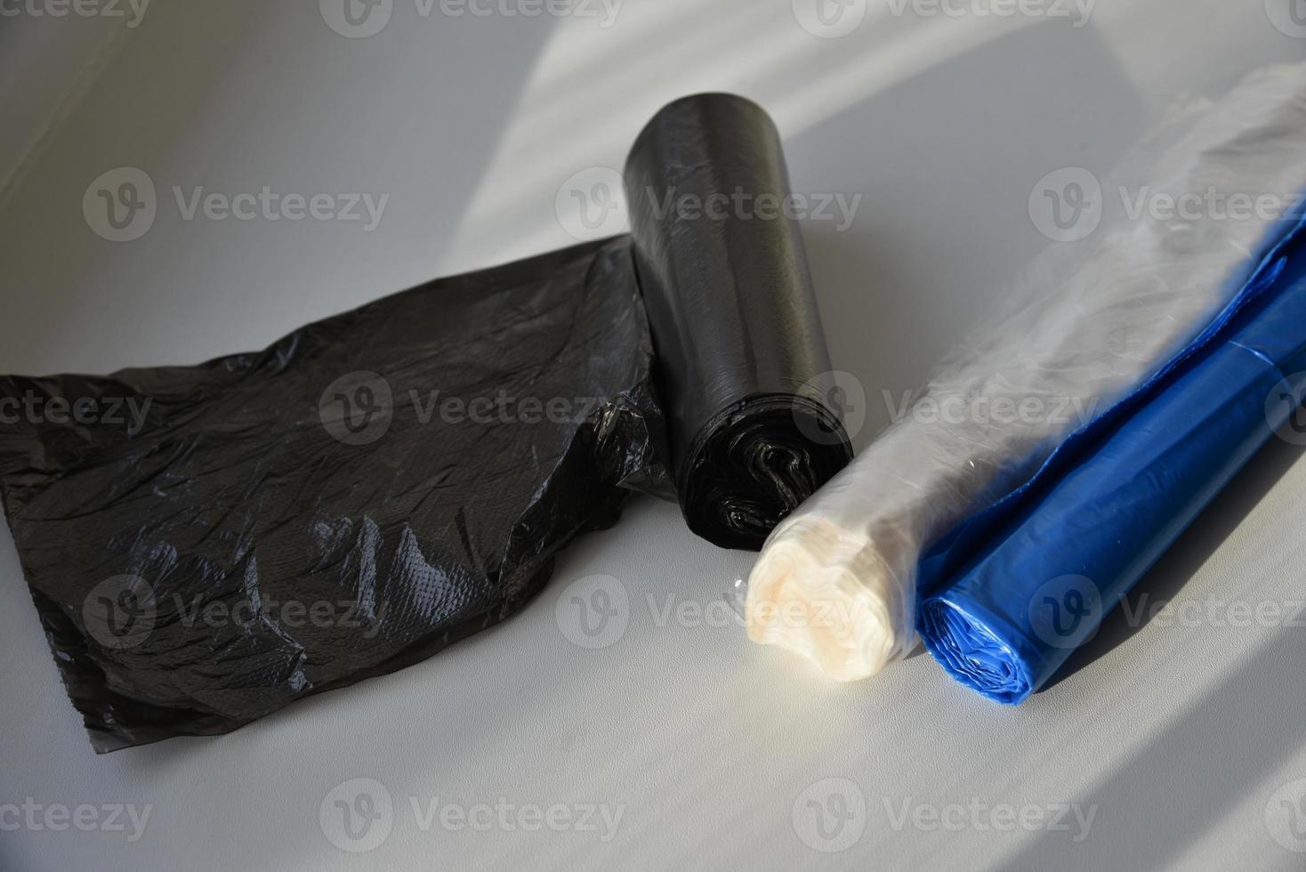 Plastic garbage bags in rolls on a white background photo