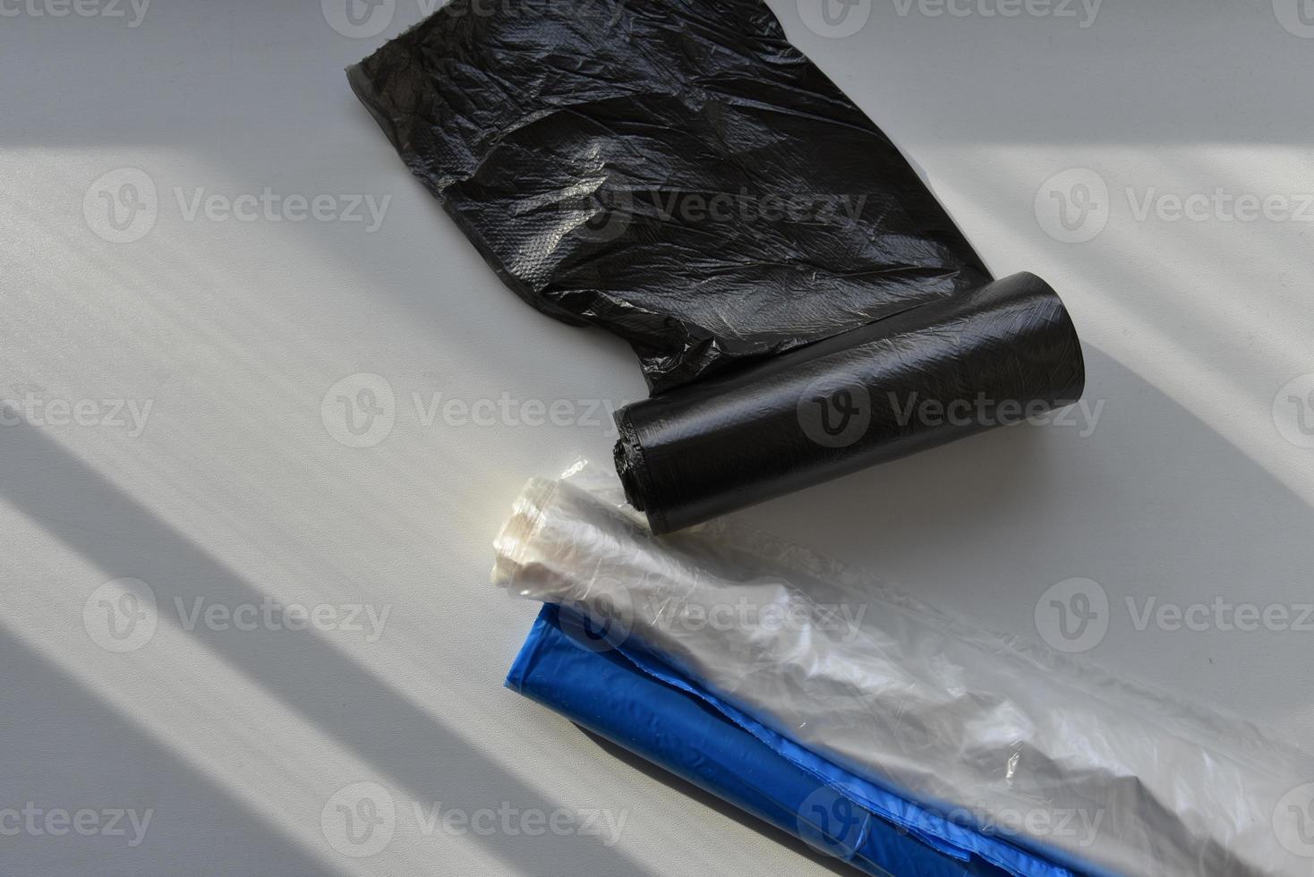 Plastic garbage bags in rolls on a white background photo