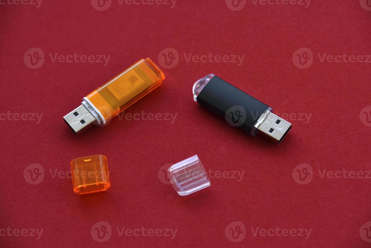 Various USB flash drives on a red background photo