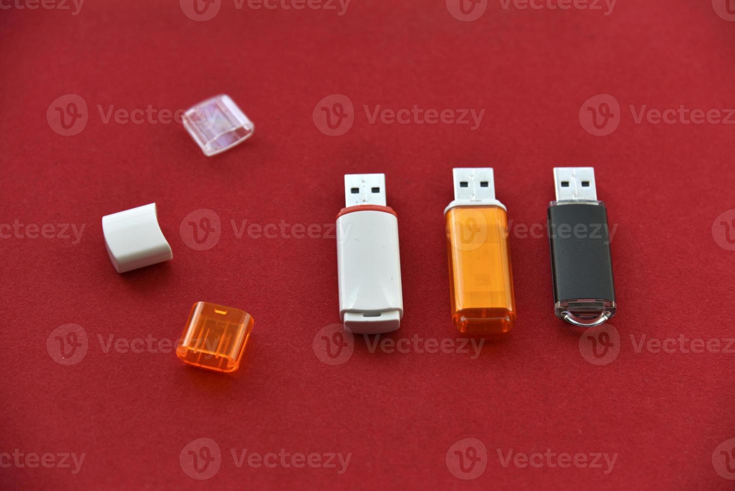 Various USB flash drives on a red background photo