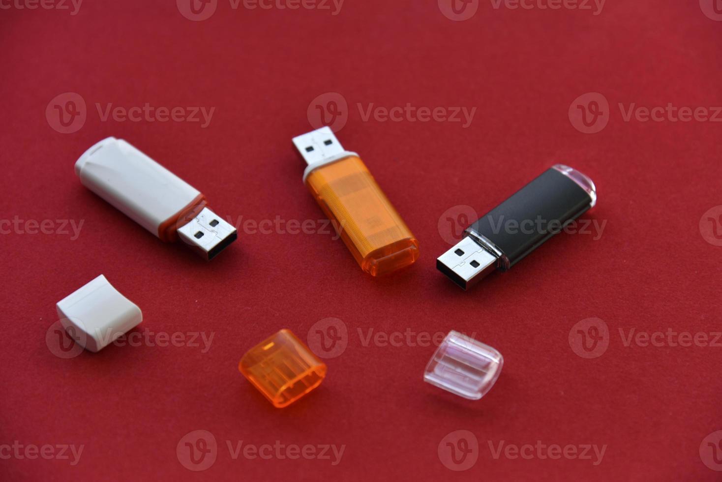 Various USB flash drives on a red background photo
