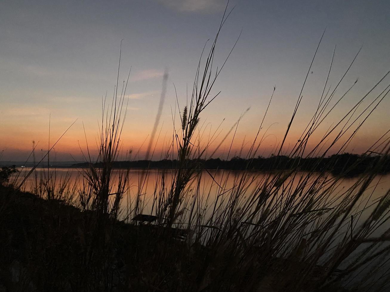 silueta del cielo del atardecer en el fondo del río foto