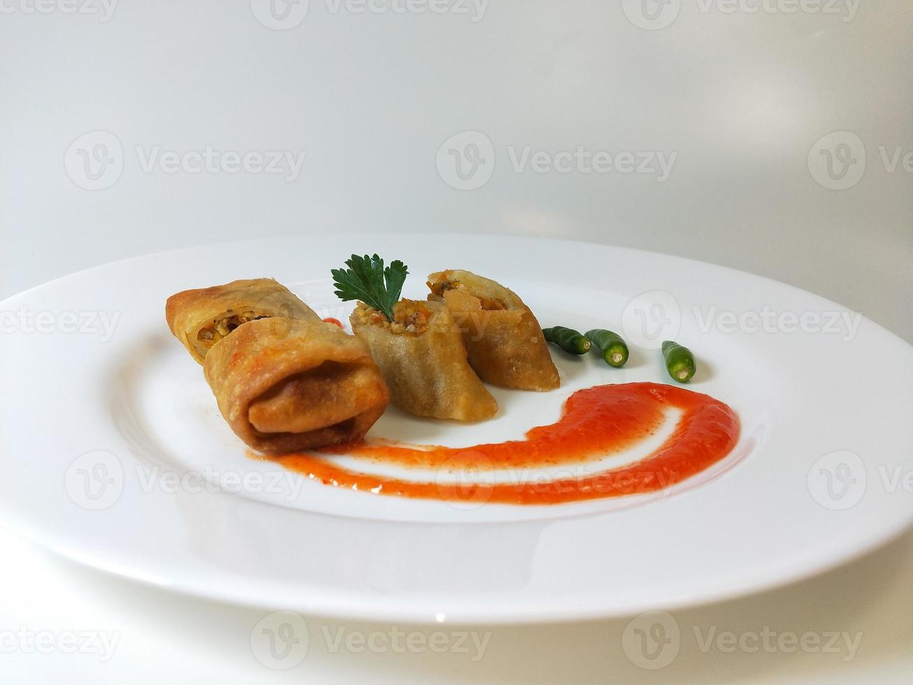 Lumpia is a typical Central Javanese Indonesian snack consisting of a mixture of young bamboo shoots, eggs, fresh vegetables, and meat or seafood, in a roll made of thin sheets of wheat flour photo