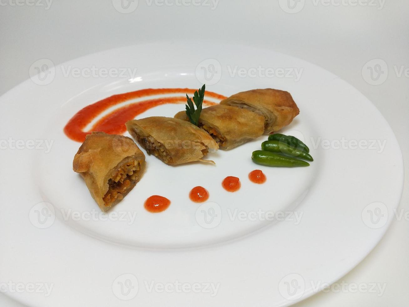 Lumpia is a typical Central Javanese Indonesian snack consisting of a mixture of young bamboo shoots, eggs, fresh vegetables, and meat or seafood, in a roll made of thin sheets of wheat flour photo