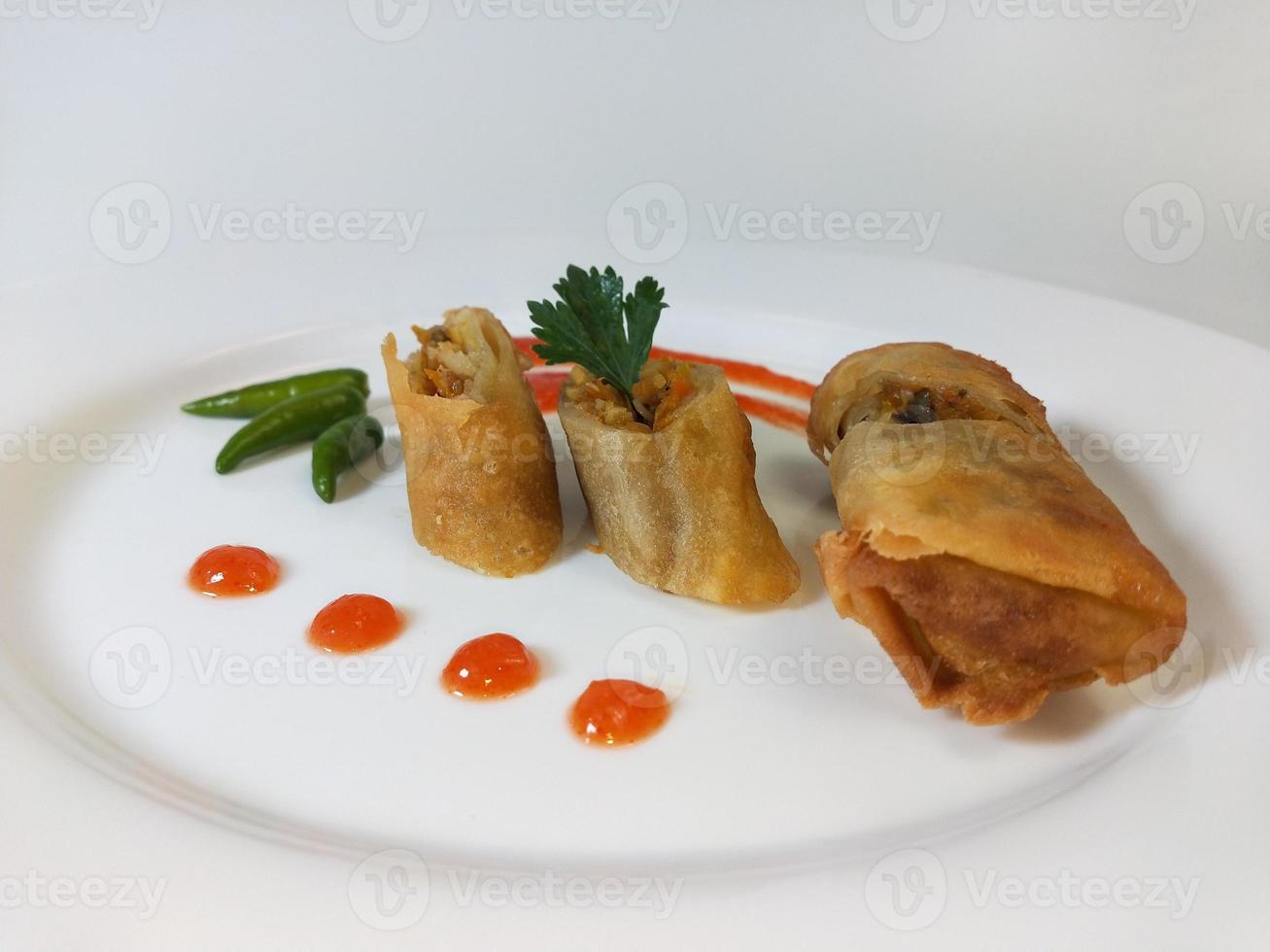 Lumpia is a typical Central Javanese Indonesian snack consisting of a mixture of young bamboo shoots, eggs, fresh vegetables, and meat or seafood, in a roll made of thin sheets of wheat flour photo