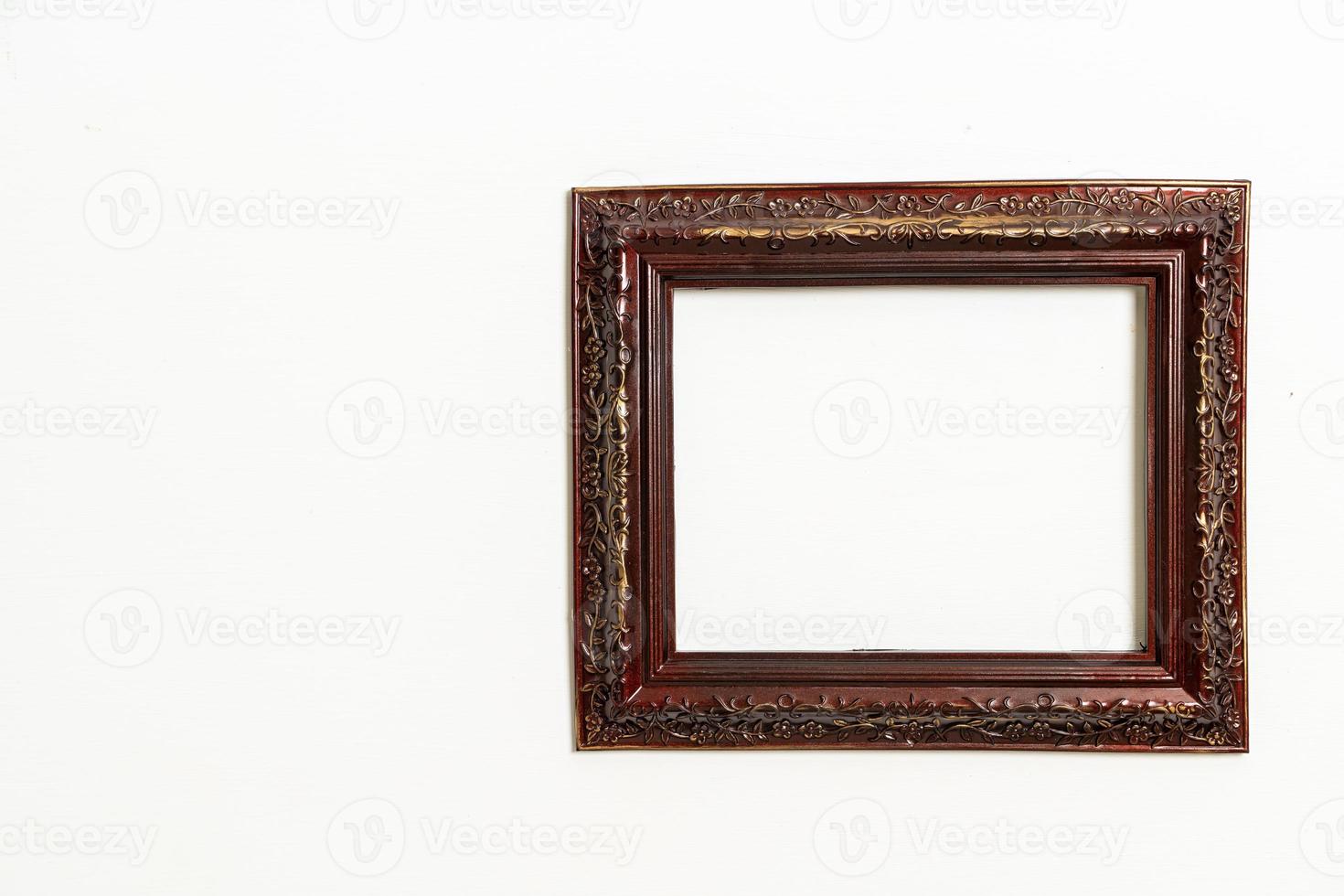 empty picture frame on white wall background photo