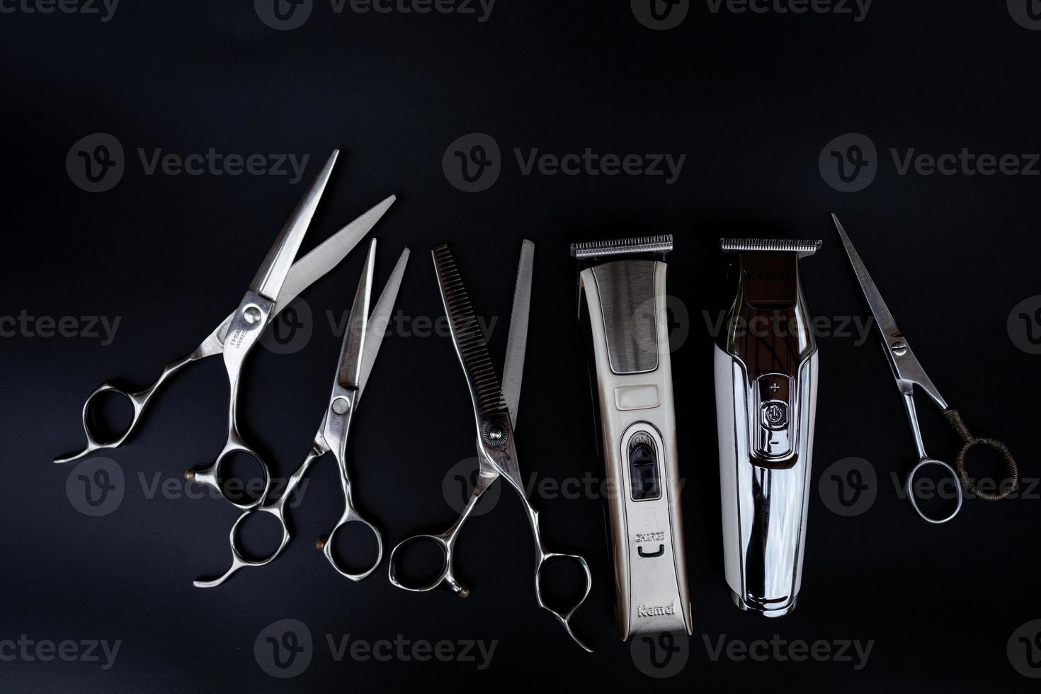 A set of hair cut tools on black background for cutting barber beard salon photo