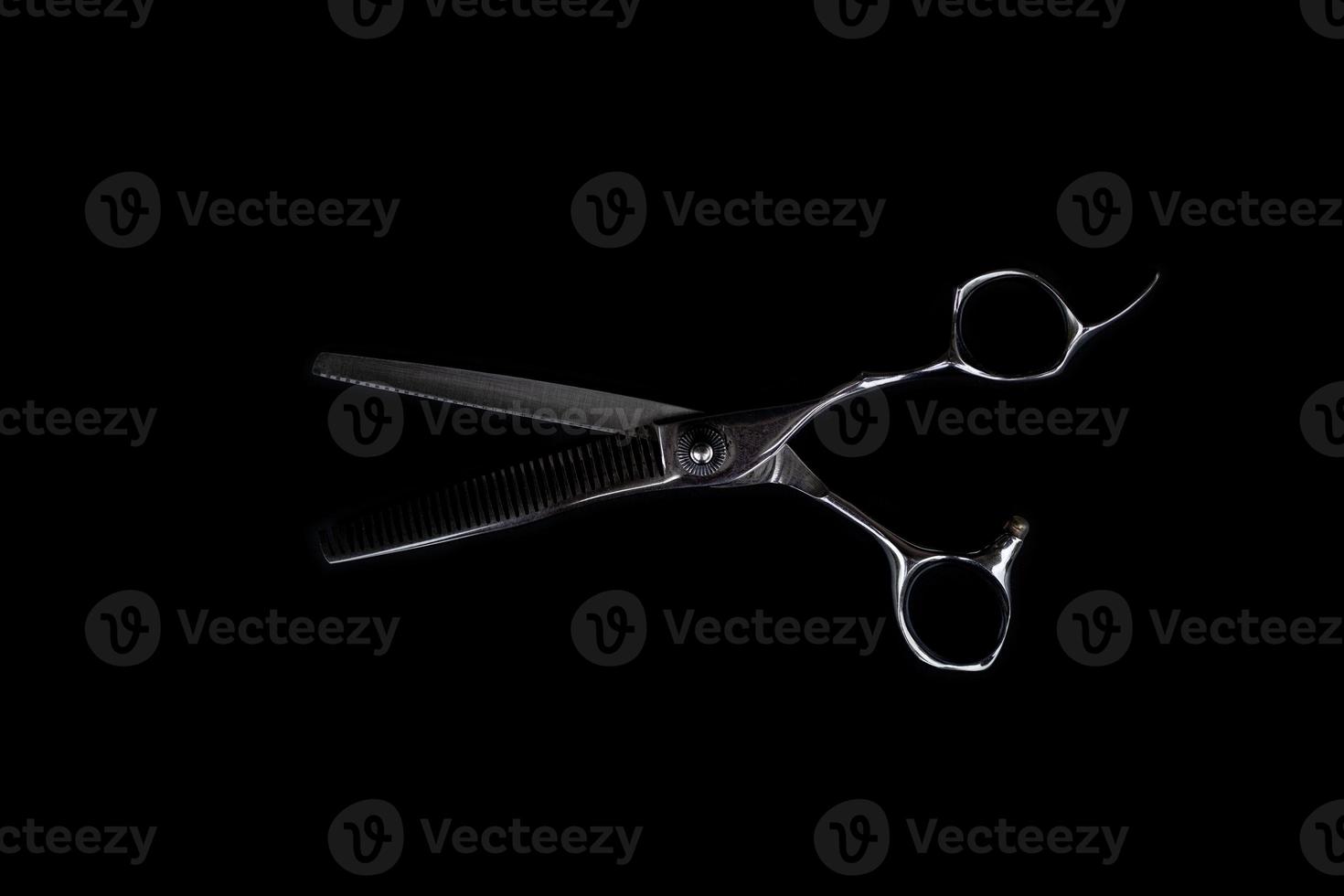 A set of hair cut tools on black background for cutting barber beard salon photo