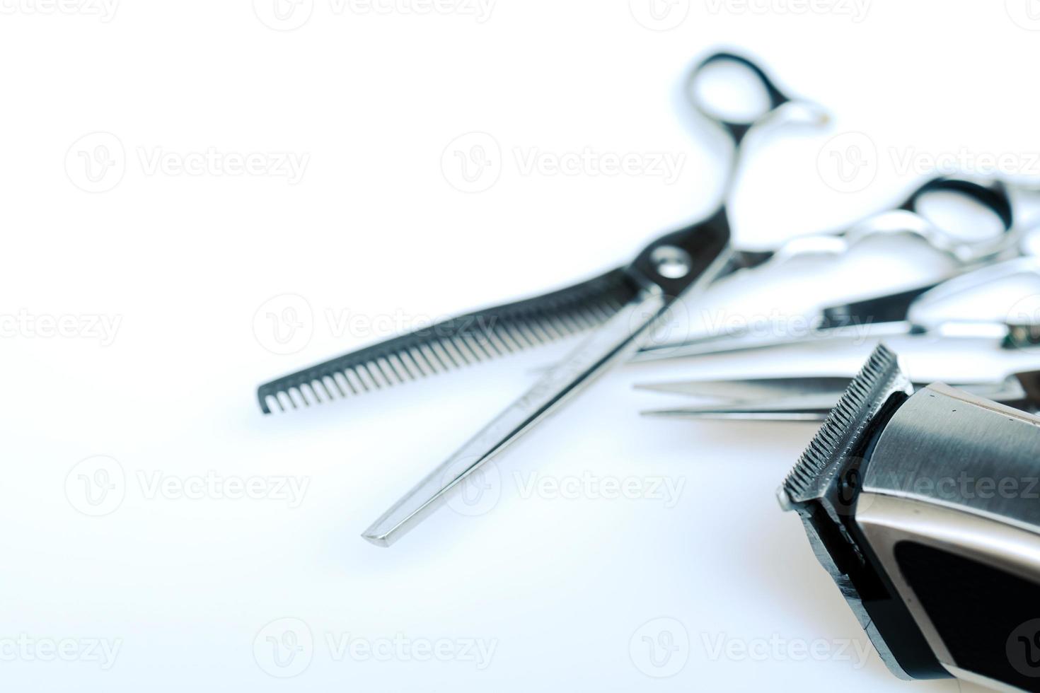 Professional barber's hair cutting tools set on white background. photo