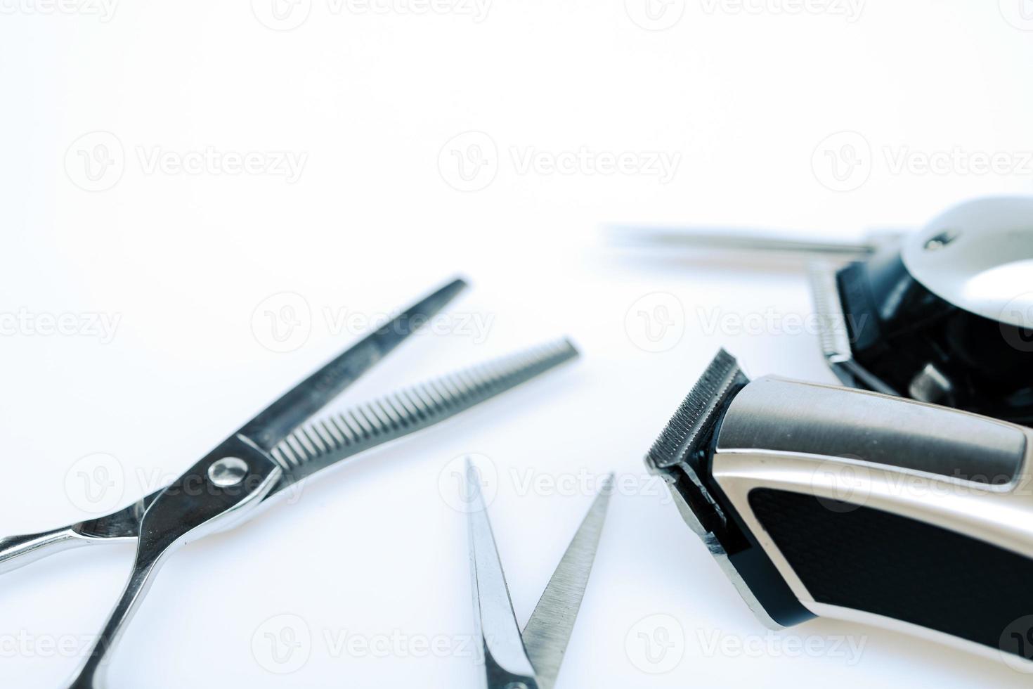 Professional barber's hair cutting tools set on white background. photo