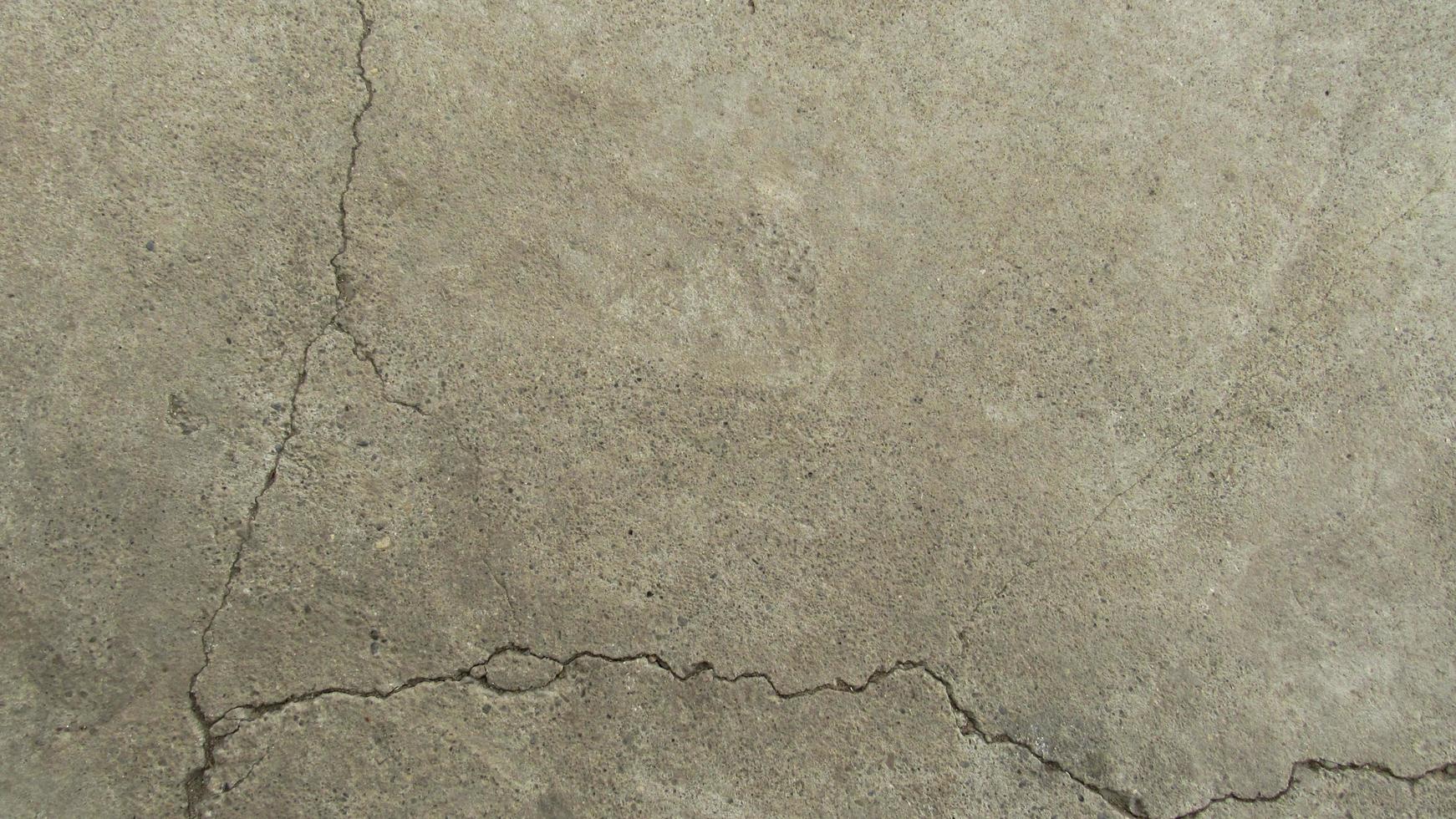old cracked concrete. Grunge concrete cement wall with crack, for your design and background texture. stone walkway. concrete texture photo