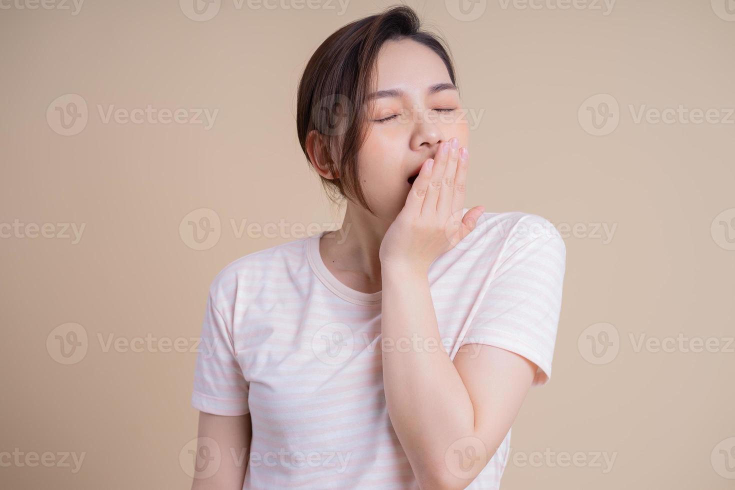 Portrait of young Asian girl posing on background photo