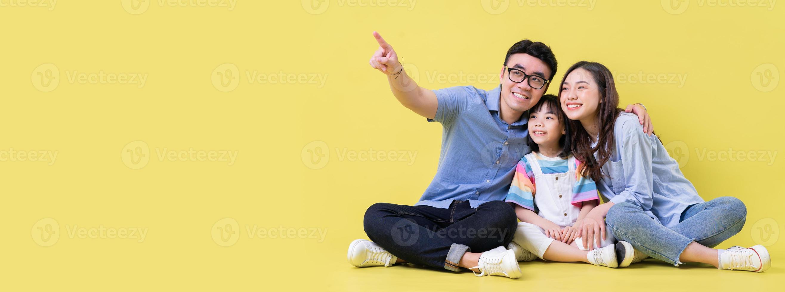 Portrait of young Asian family on background photo