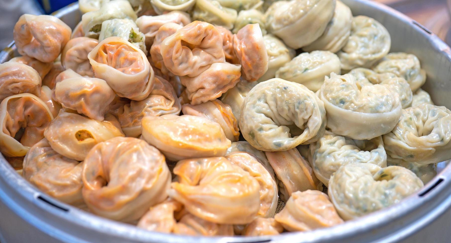 Delicious steamed round shaped dumplings in South Korea traditional market, special korean street food cuisine, close up, bokeh, copy space photo