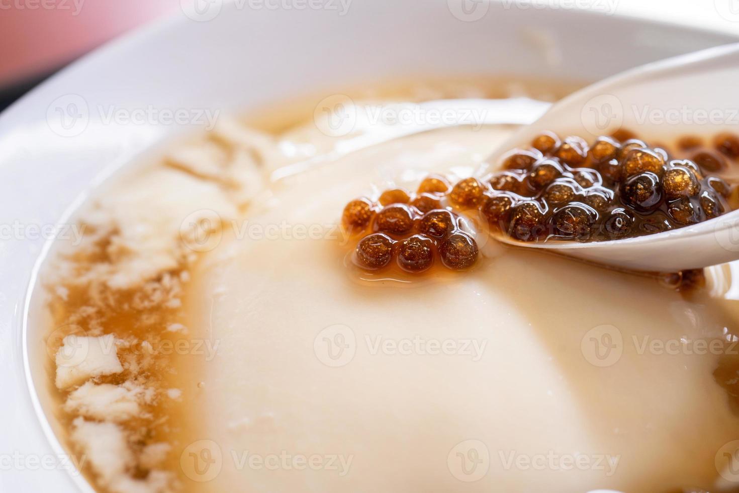 Popular Taiwan gourmet - Dessert of tapioca pearl ball bubble mixed bean curd tofu pudding douhua, dou hua in white bowl, close up, lifestyle photo