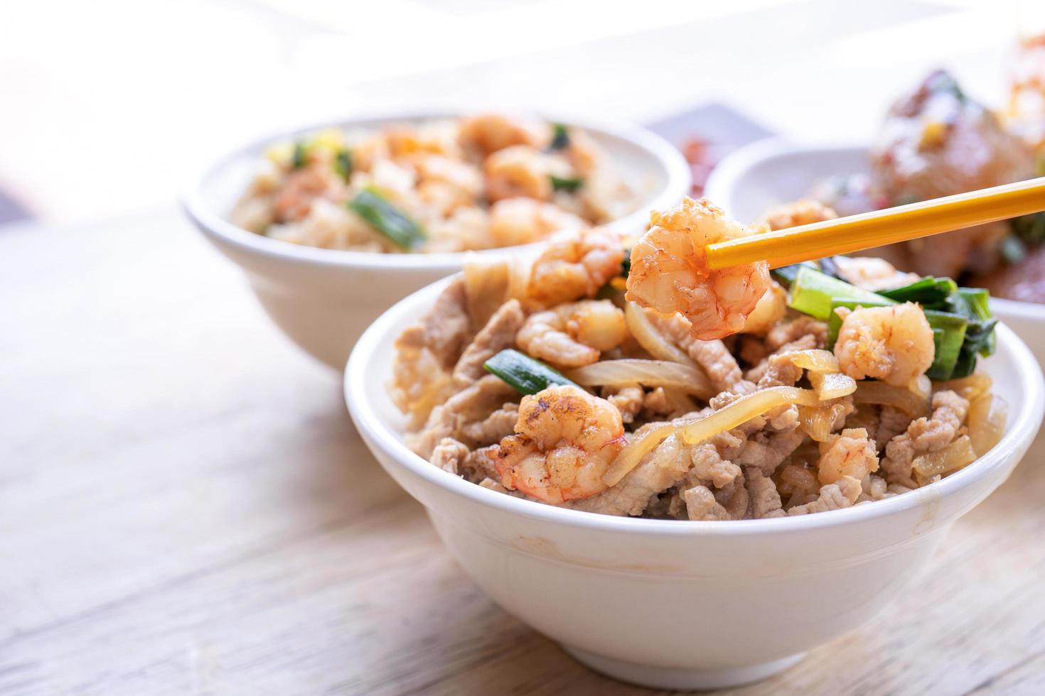 Braised shrimp over rice - Taiwan famous traditional street food. Soy-stewed prawn and sliced pork on cooked rice. Travel concept, copy space, close up photo