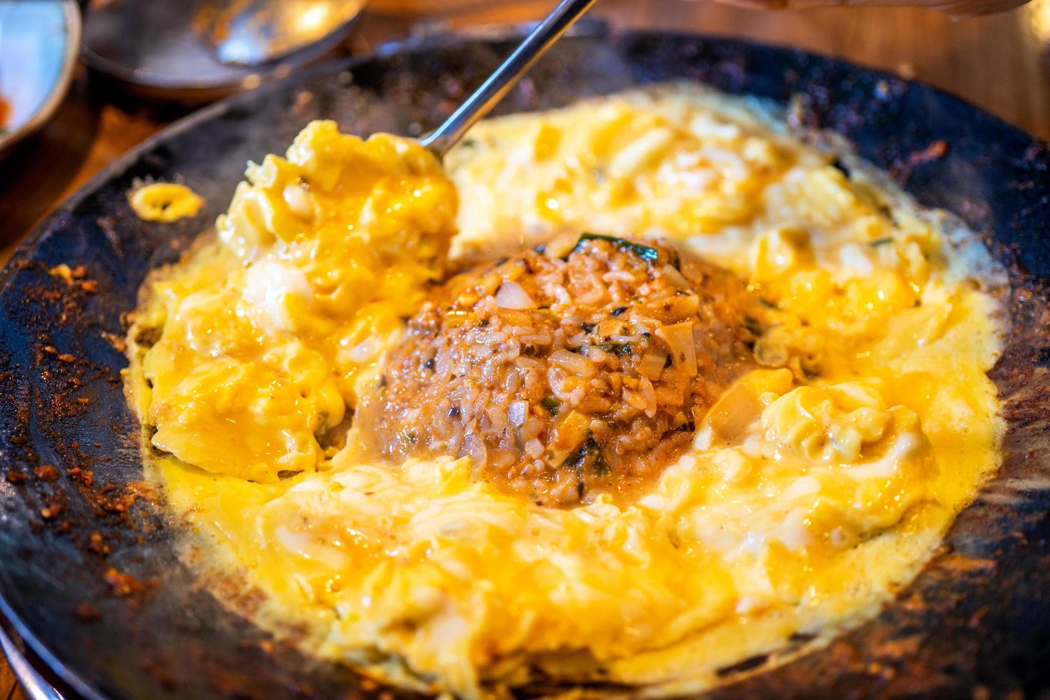 Delicious volcanic shaped fried rice with egg and spicy sauce, pork and squid, famous south korean food in jeju island restaurant, close up photo