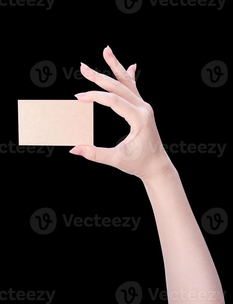 Young asia clean girl hand holding a blank kraft brown paper card template isolated on black background, clipping path, close up, mock up, cut out photo