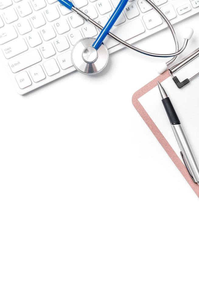 Medical Concept - Stethoscope on computer keyboard on white background. Physician long term care treatment concept. Top view, flat lay, copy space photo