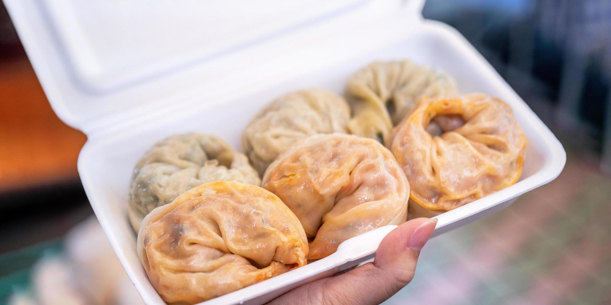 Delicious steamed round shaped dumplings in South Korea traditional market, special korean street food cuisine, close up, bokeh, copy space photo