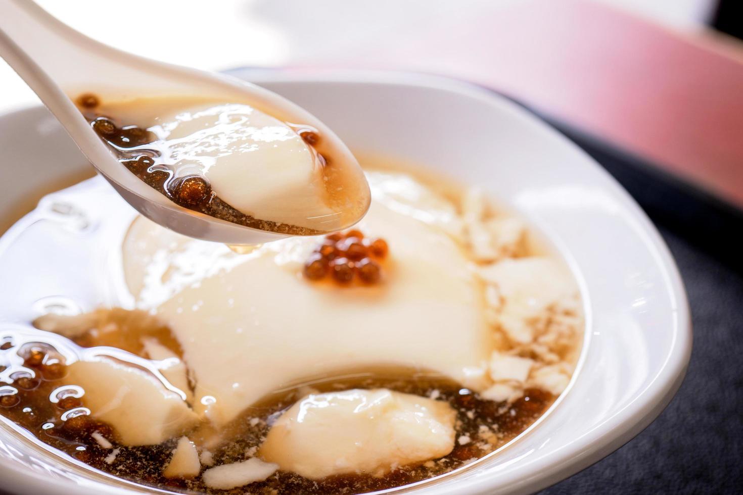 Popular Taiwan gourmet - Dessert of tapioca pearl ball bubble mixed bean curd tofu pudding douhua, dou hua in white bowl, close up, lifestyle photo