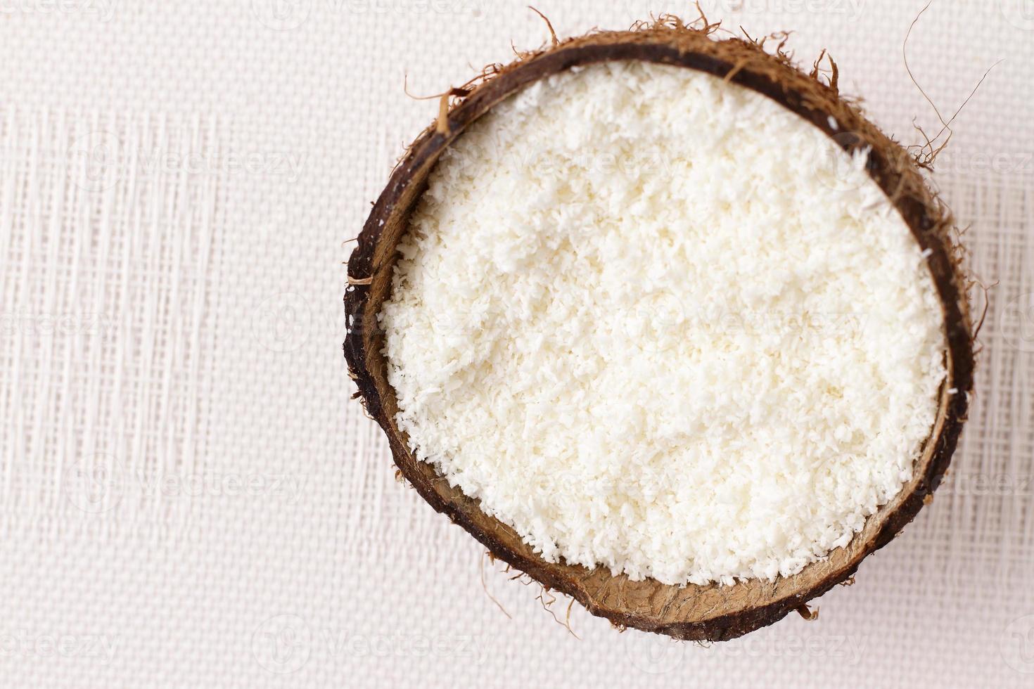 Natural coconut flakes in shell, copy space photo