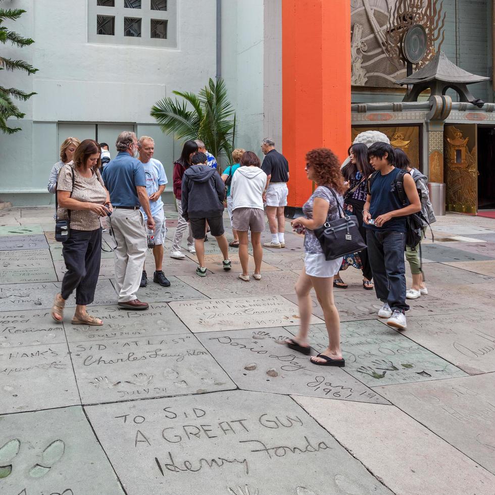 HOLLYWOOD, CALIFORNIA, USA, 2011. People looking at the handprints, footprints and signatures of the stars in Hollywood on July 29, 2011. Unidentified people photo