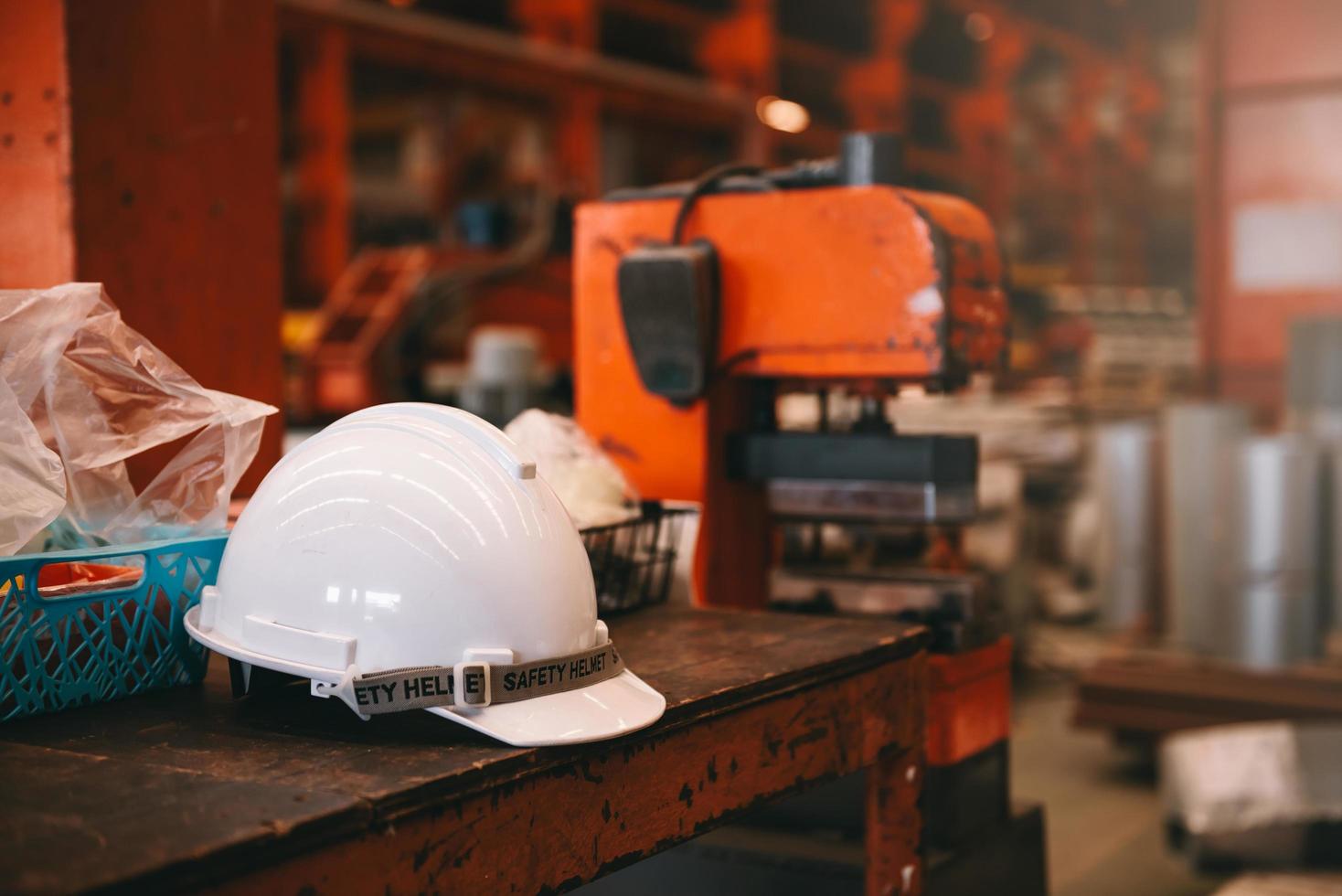 casco de seguridad de casco blanco en el lugar de trabajo de la fábrica con espacio de copia. ingeniería, concepto de fábrica foto