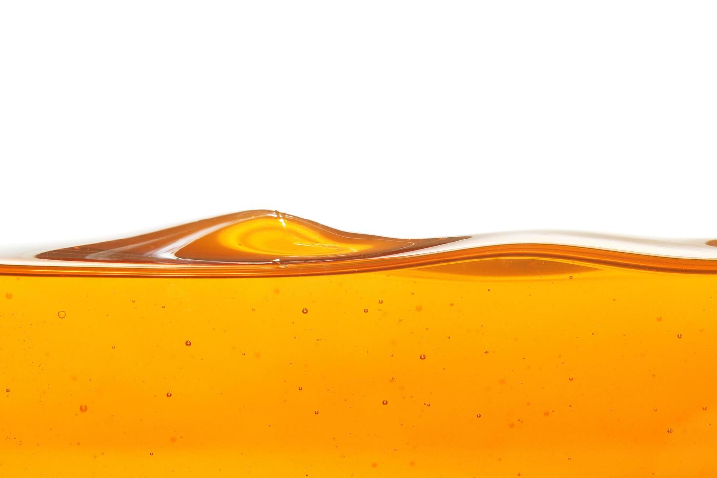 Wave of oil viscosity and air bubbles inside oil isolated on white background. photo