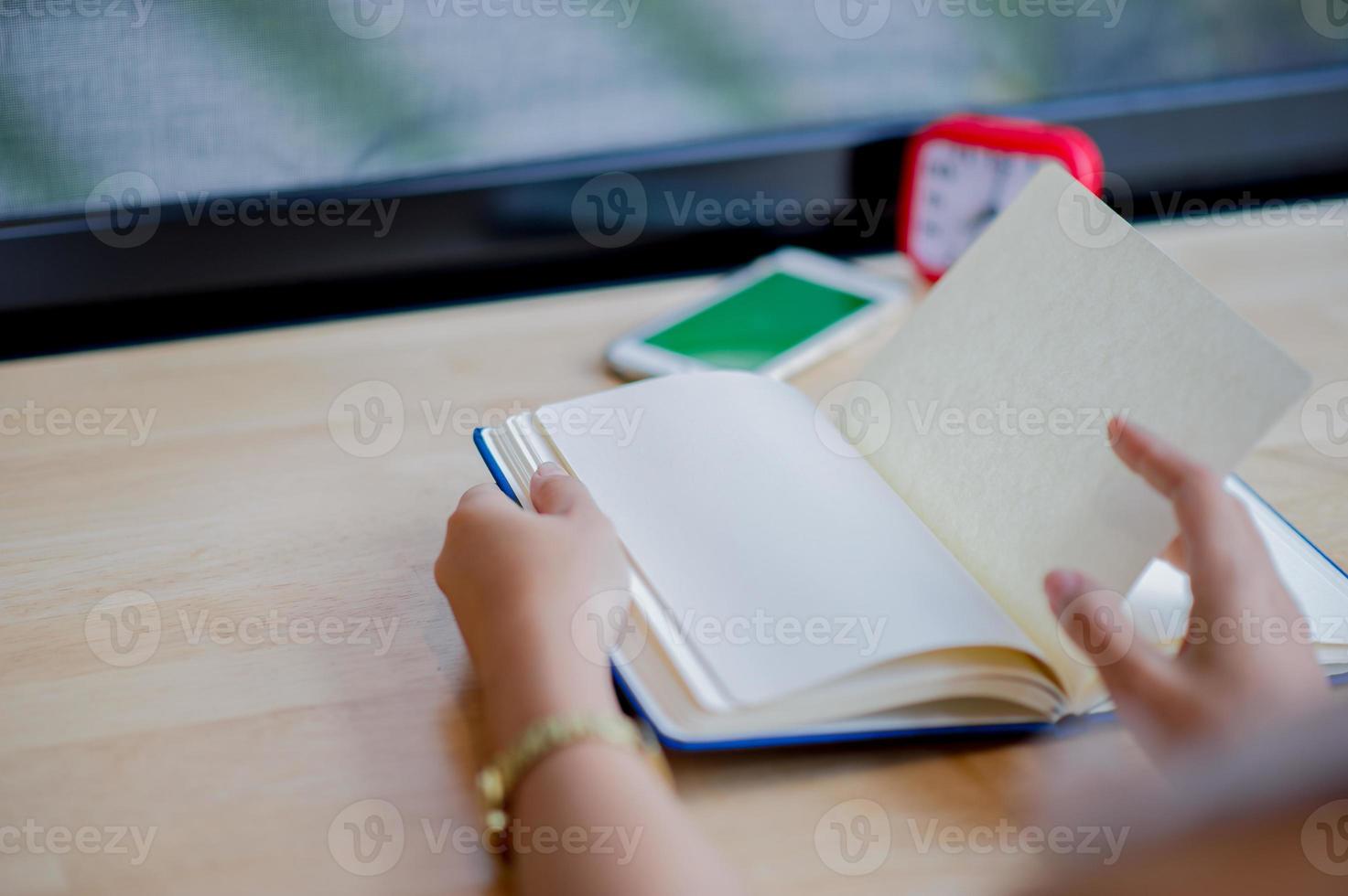 Hands and books that are laid bare with space In the morning room Book reading concept photo